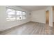 Bright, open living room featuring modern flooring, neutral walls, and a large window for ample natural light at 4601 Mendham Dr, Charlotte, NC 28215