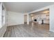 Bright living room with neutral paint, open floorplan, and wood-look flooring at 4601 Mendham Dr, Charlotte, NC 28215