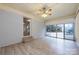 Bright sunroom features updated flooring, brick wall, and sliding glass doors to the backyard at 4601 Mendham Dr, Charlotte, NC 28215