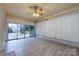 Bright sunroom with updated flooring and sliding glass doors leading to an outdoor patio at 4601 Mendham Dr, Charlotte, NC 28215