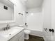 Bathroom featuring a tub/shower, single sink vanity, framed mirror, and black hardware at 4903 Jamee Dr, Gastonia, NC 28056