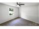 Bright bedroom featuring neutral carpet, ceiling fan, and natural light from the window at 4903 Jamee Dr, Gastonia, NC 28056