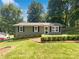 Charming single-story home featuring a well-maintained lawn, garden bed, and concrete driveway at 4903 Jamee Dr, Gastonia, NC 28056