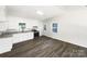 Bright kitchen featuring white cabinets, stainless steel appliances, granite countertops, and modern flooring at 4903 Jamee Dr, Gastonia, NC 28056