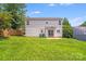 View of the spacious backyard with a sliding glass door leading into the home at 5417 Timbertop Ln, Charlotte, NC 28215