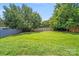 Fenced-in backyard with lush green grass and mature trees, providing privacy and shade at 5417 Timbertop Ln, Charlotte, NC 28215