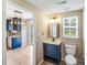 Bathroom features a modern vanity with a square mirror and a view into the adjacent kitchen at 5417 Timbertop Ln, Charlotte, NC 28215