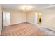 Spacious bedroom featuring carpeted floors, a modern light fixture, and neutral walls at 5417 Timbertop Ln, Charlotte, NC 28215