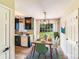 Cozy dining room adjacent to the kitchen features a modern light fixture and a view of the backyard at 5417 Timbertop Ln, Charlotte, NC 28215