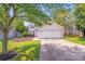 Inviting home exterior with a well-manicured lawn, attached garage, and mature trees at 5417 Timbertop Ln, Charlotte, NC 28215