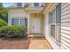 Inviting front entrance featuring a white door, neat landscaping, and neutral siding enhancing the curb appeal at 5417 Timbertop Ln, Charlotte, NC 28215