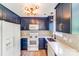 Bright kitchen with navy blue cabinetry, white countertops, and stylish light fixtures at 5417 Timbertop Ln, Charlotte, NC 28215