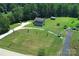 Aerial view of a two story home with large yard, mature trees, and long driveway at 550 Baker Mill Rd, Cleveland, NC 27013