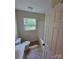 Bright bathroom featuring a clean vanity, toilet, and a shower-tub combo under a window at 550 Baker Mill Rd, Cleveland, NC 27013
