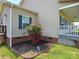 Landscaped side yard with a flower bush and view of the covered porch at 550 Baker Mill Rd, Cleveland, NC 27013