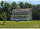 Two-story home with a covered front porch and a well-maintained yard with mature trees at 550 Baker Mill Rd, Cleveland, NC 27013
