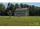 Beautiful two-story home featuring a covered front porch and a large grassy yard at 550 Baker Mill Rd, Cleveland, NC 27013