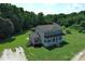 Charming two-story home with a welcoming front porch and spacious lawn surrounded by lush trees at 550 Baker Mill Rd, Cleveland, NC 27013
