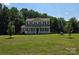 Charming two-story home with a welcoming front porch and lush green lawn surrounded by mature trees at 550 Baker Mill Rd, Cleveland, NC 27013