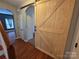 Welcoming hallway featuring a stylish barn door and hardwood floors leading to other rooms at 550 Baker Mill Rd, Cleveland, NC 27013