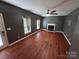 Open-concept living room with hardwood floors, fireplace, and large windows at 550 Baker Mill Rd, Cleveland, NC 27013