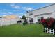 Lush backyard featuring manicured lawn and flower bed, an outdoor gazebo and a white fence at 6340 Ziegler Ln # 148-A, Charlotte, NC 28269