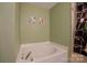 Bright bathroom featuring a corner soaking tub and modern fixtures at 6340 Ziegler Ln # 148-A, Charlotte, NC 28269