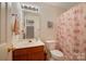 Well-lit bathroom featuring a single sink vanity, toilet, and patterned shower curtain at 6340 Ziegler Ln # 148-A, Charlotte, NC 28269