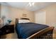 Cozy bedroom featuring a bed with blue comforter, neutral walls, and bright closet at 6340 Ziegler Ln # 148-A, Charlotte, NC 28269