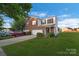 Charming two-story home with a well-manicured lawn, two-car garage, and landscaped front yard at 6340 Ziegler Ln # 148-A, Charlotte, NC 28269