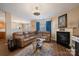 Comfortable living room features a fireplace, plush sofa, and hardwood floors at 6340 Ziegler Ln # 148-A, Charlotte, NC 28269