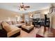 Comfortable living room with a large sectional sofa, ceiling fan, and home office setup at 6340 Ziegler Ln # 148-A, Charlotte, NC 28269