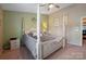 Well-lit main bedroom with a four-poster bed, ceiling fan, and neutral color palette at 6340 Ziegler Ln # 148-A, Charlotte, NC 28269