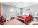 Bright bedroom with a red-accented bed, complemented by a wicker chair at 6601 Charlotte Hwy, York, SC 29745