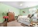 Relaxing bedroom with green walls, a floral-patterned bed, and wooden dresser at 6601 Charlotte Hwy, York, SC 29745