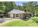 Brick home with detached garage, lush lawn, and mature trees, nestled in a serene setting at 6601 Charlotte Hwy, York, SC 29745