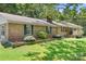 Brick home with green shutters accented by a well maintained lawn and beautiful landscaping at 6601 Charlotte Hwy, York, SC 29745