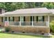 Inviting front porch with white railing, perfect for relaxing and enjoying the outdoors at 6601 Charlotte Hwy, York, SC 29745