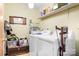 Practical laundry room with modern appliances, overhead shelving, and storage solutions at 6601 Charlotte Hwy, York, SC 29745