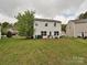 Back of house showing big yard with mature tree and green space at 7024 Sunman Rd, Charlotte, NC 28216