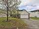 Inviting two-story home with brick accents, a two-car garage, and mature landscaping, enhancing its curb appeal at 7024 Sunman Rd, Charlotte, NC 28216