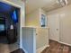 Upstairs hallway featuring hardwood floors, neutral paint, and access to bedrooms at 7024 Sunman Rd, Charlotte, NC 28216