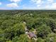 Overhead shot of neighborhood, showcasing lush tree coverage and mountain views in the distance at 747 9Th Nw St, Hickory, NC 28601