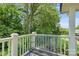 Back porch showcasing a comfortable metal bench and an overlooking view of the wooded backyard at 747 9Th Nw St, Hickory, NC 28601