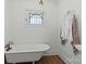 Bright bathroom with a clawfoot tub and stained glass window, creating a relaxing space at 747 9Th Nw St, Hickory, NC 28601