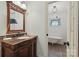 Stylish bathroom featuring a vanity with a granite top and a view of the bathtub at 747 9Th Nw St, Hickory, NC 28601