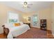 Bedroom features a day bed, ceiling fan, and access to the porch at 747 9Th Nw St, Hickory, NC 28601
