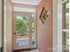 A charming entryway with a glass door leading to the front porch, natural light, and brick walls at 747 9Th Nw St, Hickory, NC 28601