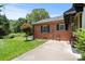 Exterior of a brick home featuring a well-maintained lawn, patio, and mature landscaping at 747 9Th Nw St, Hickory, NC 28601