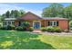Charming brick home with a well-manicured lawn and a welcoming blue front door at 747 9Th Nw St, Hickory, NC 28601